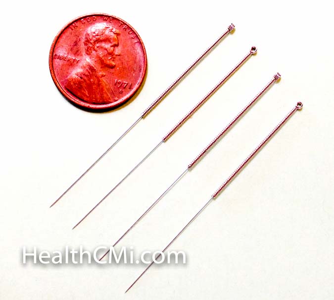  Four filiform needles against size of a penny