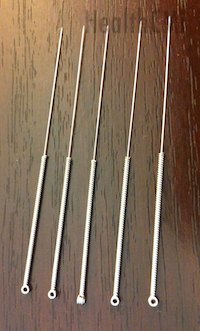 Five needles with wound handles of Chinese style are shown. 