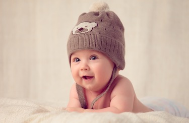 An infant wearing a hat. 