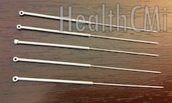 Five stainless steel needles with wound handles depicted. 