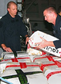 US Navy is depicted seizing illegal cocaine shipment.