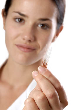 Needles in hand of acupuncturist. 