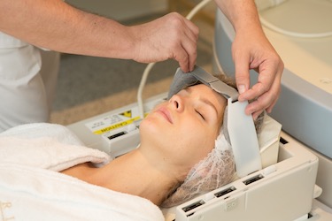 A woman is prepped for an MRI. 